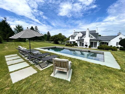 Hamptons Style Luxury Inground Pool with Tanning Chairs. 
