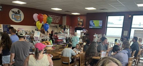 Crowds enjoying coffee at The Screaming Bean in Aberdeen, MD, a busy local coffee shop known for handcrafted drinks and community events.