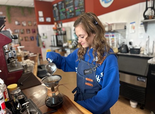 Barista crafting espresso at The Screaming Bean in Aberdeen, MD, demonstrating skill, care, and attention to detail.