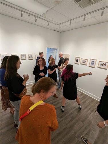 Artist enjoying their reception with guests.