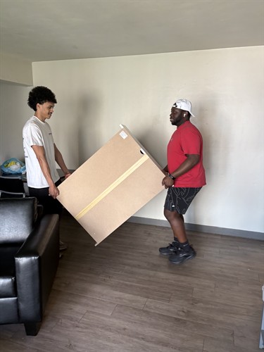 Gallery Image CampusHaul_Movers_moving_a_dresser.jpeg