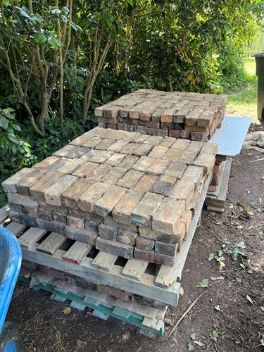 old, reclaimed bricks waiting for their new home