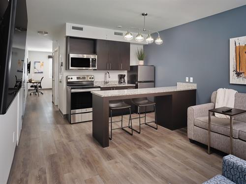 500 sqft* suites with full-size kitchen.