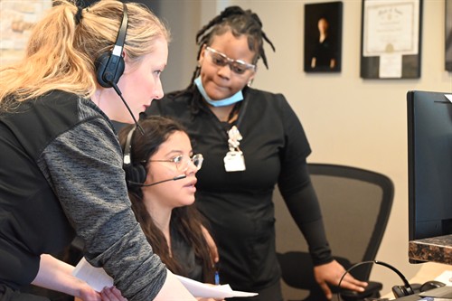 Secure Dental Davenports' patient care team working together at the front desk.
