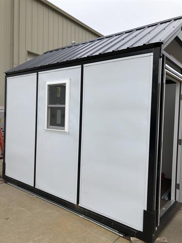 Structure with insulated hard side panels, door, window, electrical package, and heating/air conditioning unit. Structure with insulated hard side panels, door, window, electrical package, and heating/air conditioning unit.