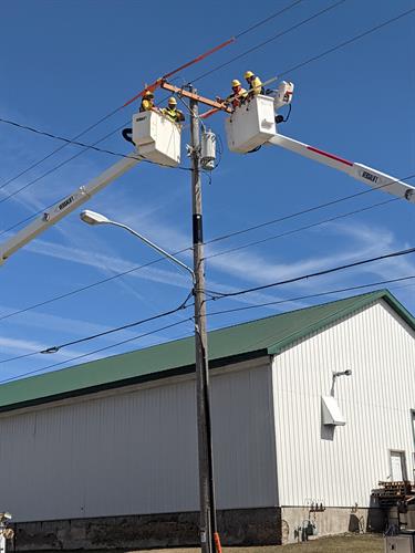 Lineman changing a cross arm