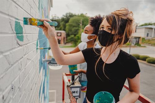 Ellie Borromeo paints with co-muralist Xaivier Ringer