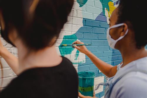 Co-muralists painting together