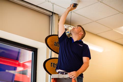 Tech installing a camera