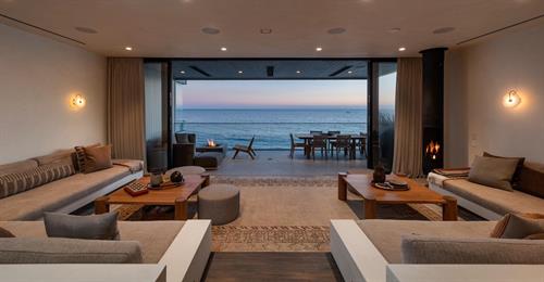 Living space opening to the ocean at a Malibu Pier residence.