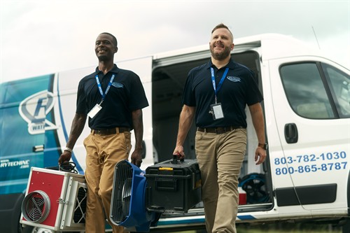 Some of our experienced, IICRC-certified team walking up to a site