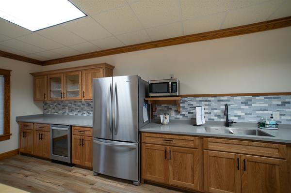 Meeting room with fridge, microwave, sink, & dishes