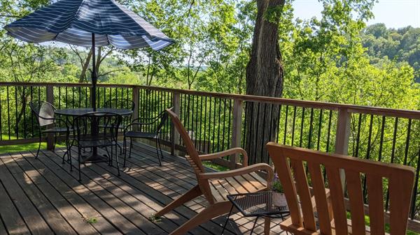 A dining table, BBQ and Adirondacks are provided on suite decks