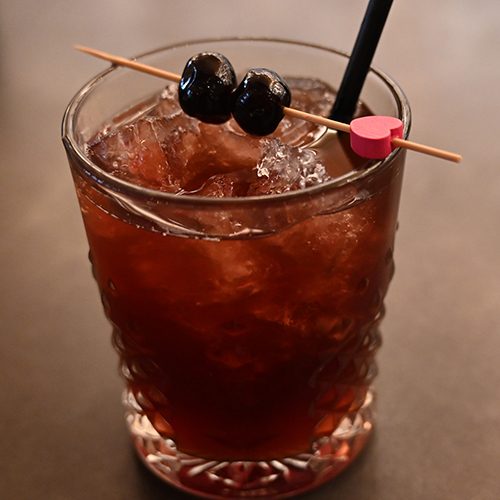 Cupid's Kiss. Handen Potato Vodka  blended with Cacao Tea, Luxardo Cherry Syrup, and Club Soda. Topped with a dash of  Scottish Aphrodite Bitters.