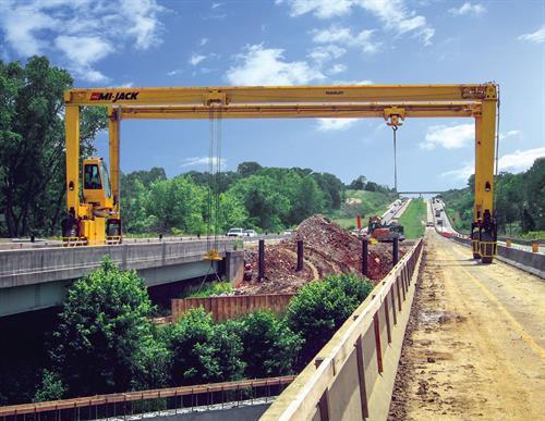 Bridge-building cranes with below-grade capability