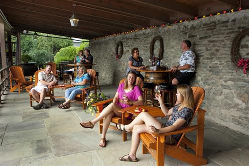 Customers enjoying wine on the patio at Hazlitt Red Cat Cellars.