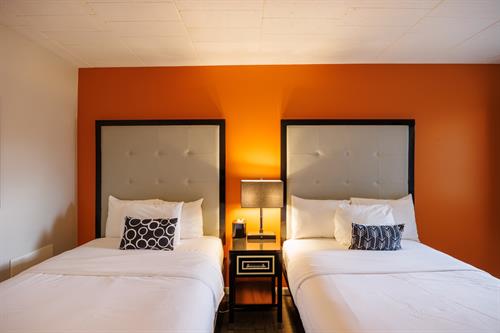 The Premium Double Room: Ideal for dual travelers who value space and style. All decorated in a modern style, these rooms offer two Full size beds, bathroom with tub/shower, desk, mini fridge, microwave, 42" Tv and Apple Tv.