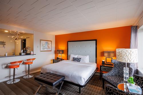 The Signature King Room: Our classic flagship room combining comfort with signature style. All decorated in a modern style, these rooms offer a King size bed, wet bar with two counter stools, mini fridge, microwave, bathtub/shower, 55" Tv and Apple Tv.