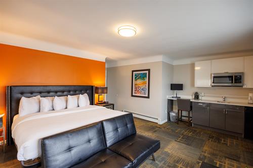 Penthouse Executive King: Our elevated 2nd floor room featuring premium amenities and maximum space. This modern decorated room offers a King size bed, large bathroom layout with walk in glass shower, futon, mini fridge, microwave, cabinets with counter space and apple tv.