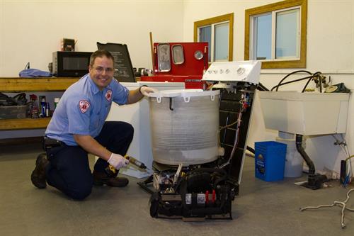 Blake working on a washing machine.