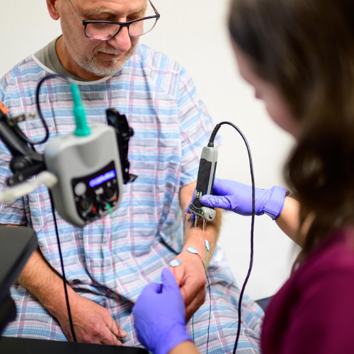 Nurse practitioner performing EMG electrodiagnostic testing at MIND.
