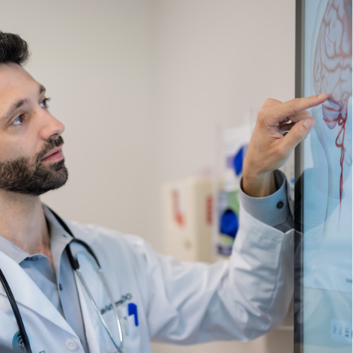 Dr. Jake Katzman, neurologist at MIND, consults with a patient using exam room digital displays. 