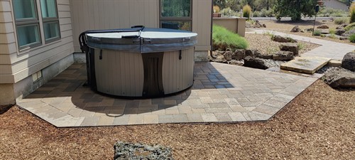 Hot tub, pavers, and stone bridge