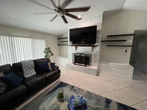 Custom Built-Ins with Floating shelves and integrated power and charging stations, custom painted brick Custom Built-Ins with Floating shelves and integrated power and charging stations, custom painted brick