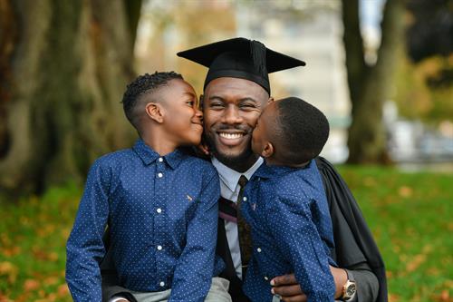 A Marjon graduate celebrating with their young family