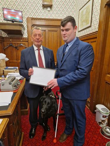 Brandon presenting a gift to RT. Hon. Lord David Blunkett after being invited to the Palace of Westminster.