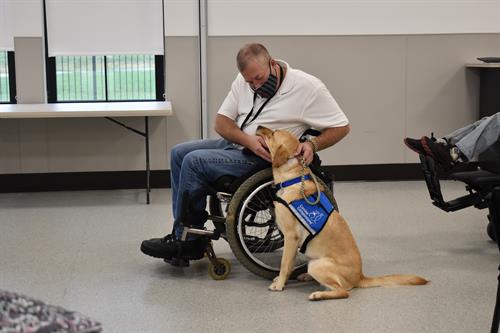 A Canine Companions client hugging newly matched with service dog during Team Training.