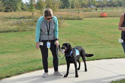 A Canine Companions client practicing the command, "get," with her newly matched with service dog. 