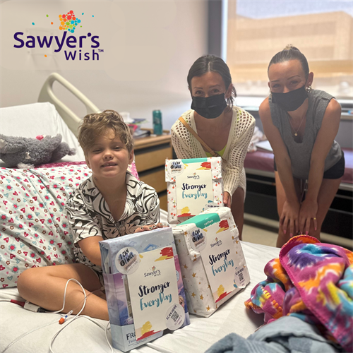 Volunteers Lindsay and Chloe proving sheets to a patient at Children's Health in Amarillo, Texas