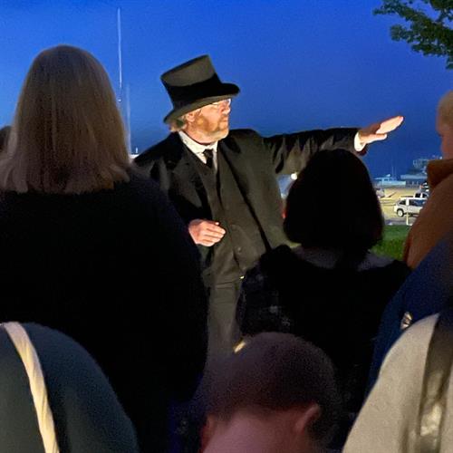Our guides are animated and professional storytellers. Here one of our guides tells a ghostly tale at the waterfront. We also include EVPs of our spirits when available!