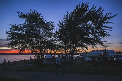 Families enjoy the sunset along the shoreline with a fantastic RV setup