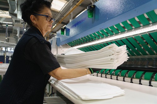Clean ironed and folded sheets at our Yeovil laundry