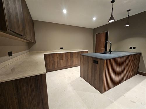Boot room with marble worktop and granite peninsula
