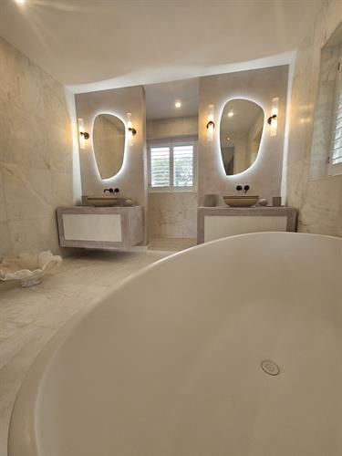 Bathroom with double marble shower and free standing bath