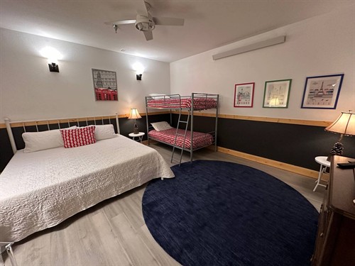 King bed with twin bunks and large smart TV