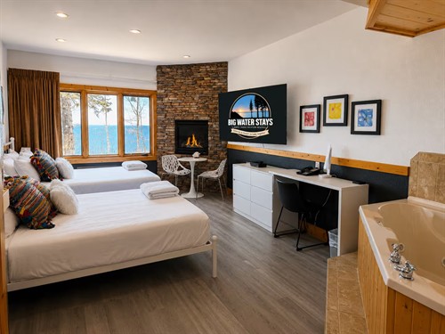 2-bed queen suite with large corner jetted tub, ensuite bathroom, desk, bistro set and large smart TV