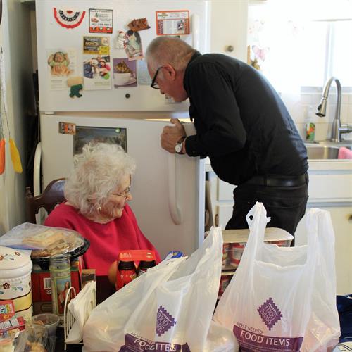 Joe unloads groceries for his mother, Bernice, who participates in our Elder Share program.