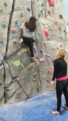 Volunteer mentors are matched with one student to be a positive adult role model in that Dreamer Scholar's life. Here, one of our mentors and her mentee try out rock climbing together. 