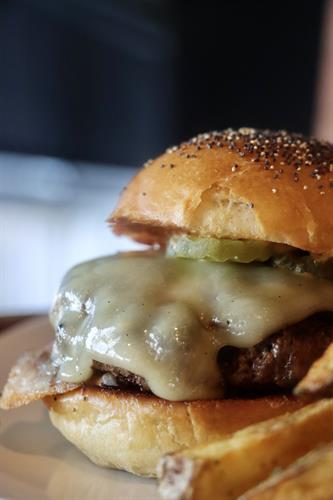 Happy Burger- grass fed patty, house made bun, pickles, cheddar, onions and fancy sauce