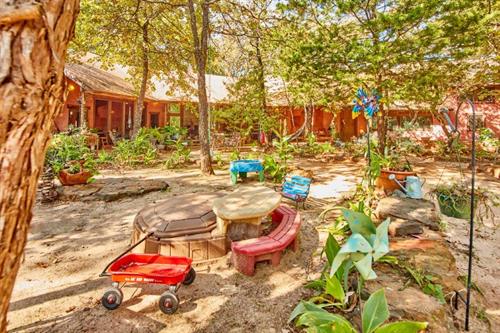 Lodge Toddler play area with sandbox, red wagon, tonka trucks, swings & hammocks