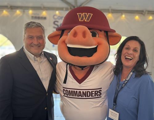 Angela and Commanders mascott with the CEO of NWFCU Jeff Bently