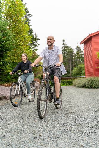Guests riding bikes on the property.