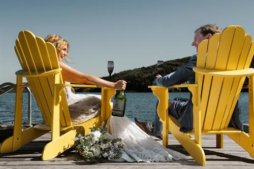 Bride and groom celebrating on the dock at Lodging at Goose Cove.