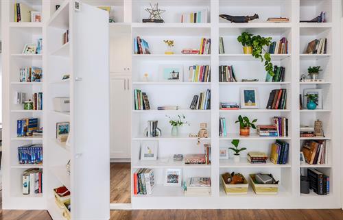 Austin Home Renovation - hidden bookshelf opens to hidden laundry room