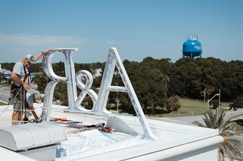 A&R Group's signage being lifted into place