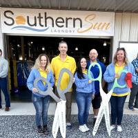 The South Baldwin and Coast Business Chambers cut a ribbon with Southern Sun Laundry of Foley